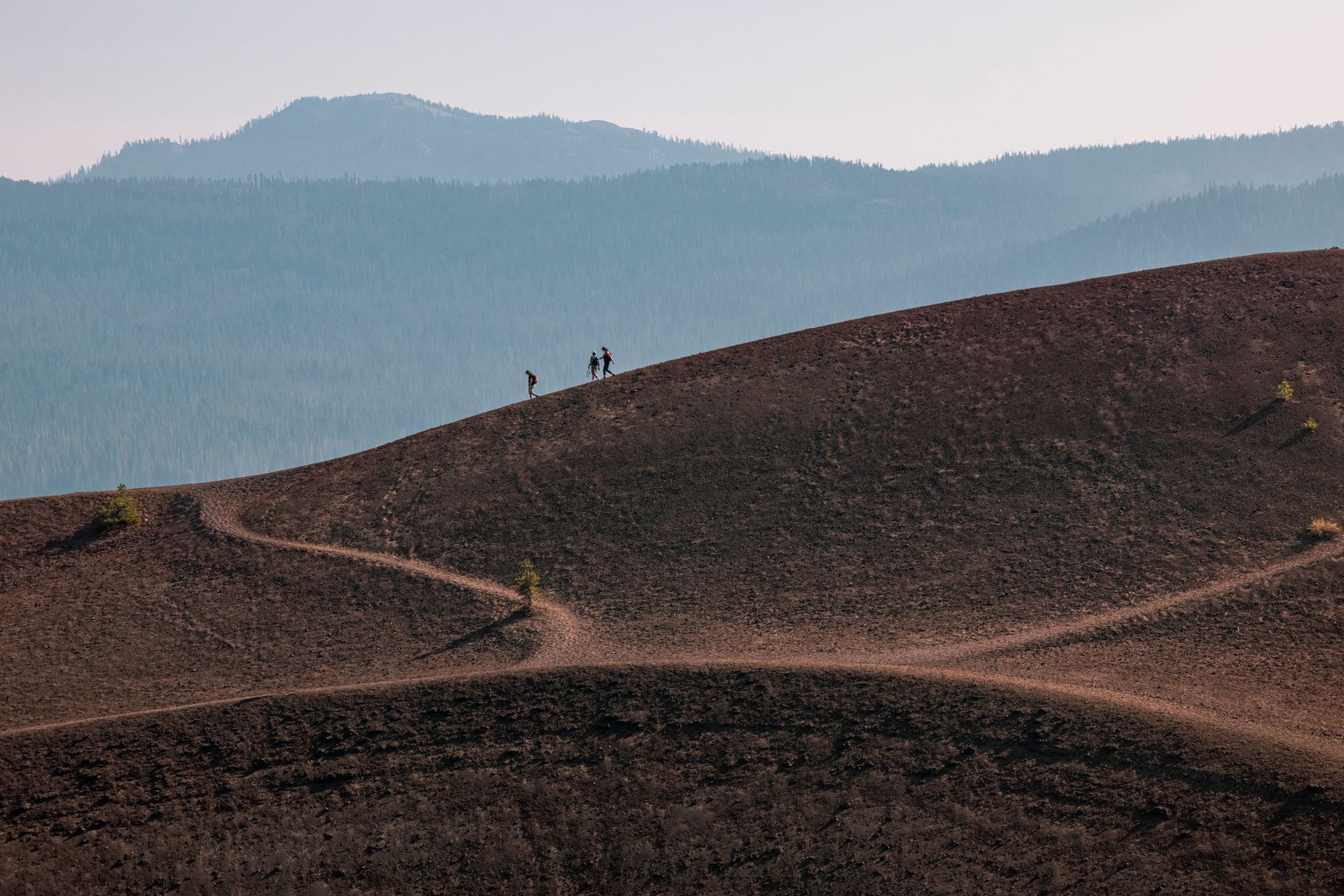 Small expedition group walking through mountain pass