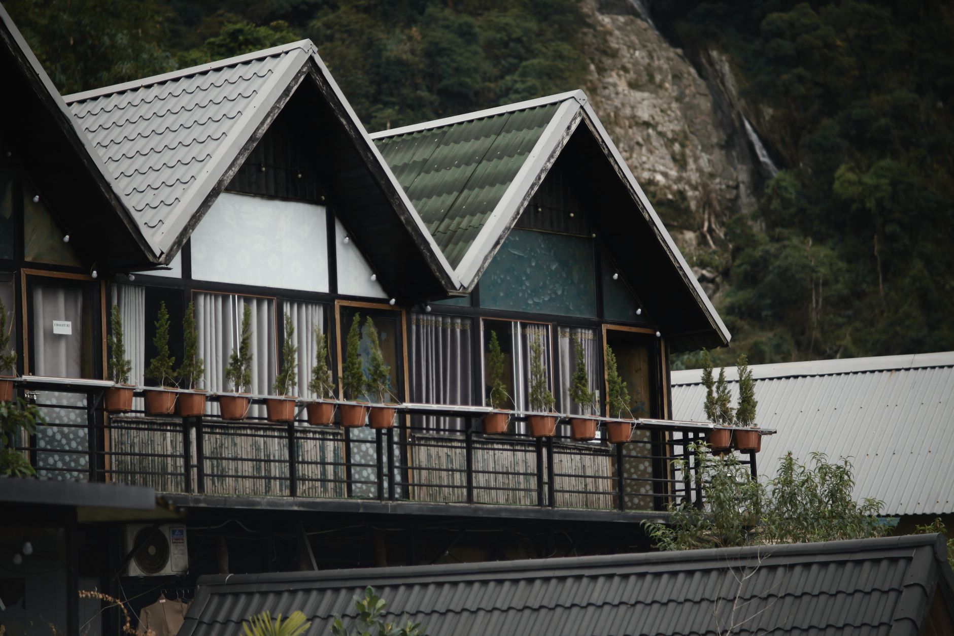 Refined eco-resort balcony overlooking misty mountain valley